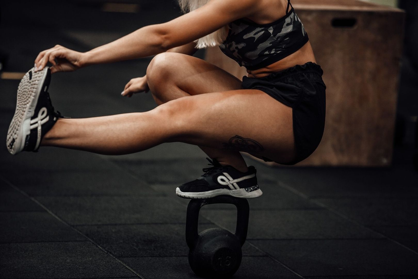 Athlete performs a single-leg balance exercise with a kettlebell